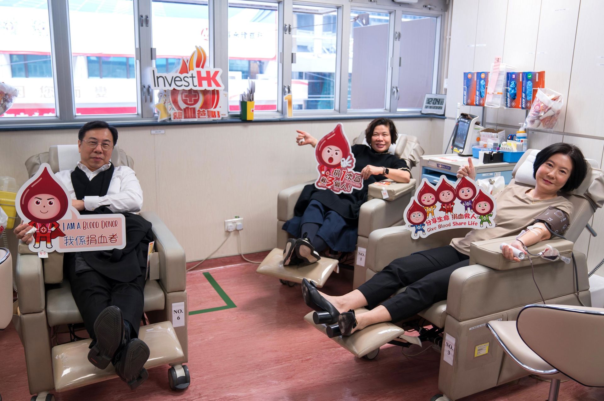 The Director-General of Investment Promotion, Ms Alpha Lau (right), and Associate Directors-General of Investment Promotion Mr Arnold Lau (left) and Ms Jessica Cheng (centre) indicated that blood donation was quick and painless